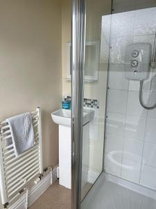 a bathroom with a shower and a sink at The Glazebury bar and restaurant with accommodation in Glazebury