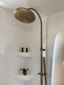 a lamp in a bathroom next to a bath tub at Mamos Sunset House Plaka in Plaka Milou
