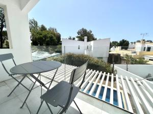 a patio with a table and chairs on a balcony at Vila Ruby - Private Pool by HD PROPERTIES in Vilamoura