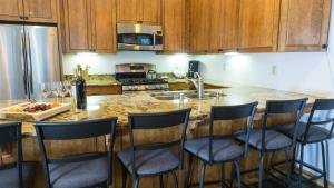 a kitchen with a counter with chairs around a kitchen island at Ski Trails 4058 in Truckee