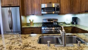 a kitchen with a sink and a stainless steel refrigerator at Ski Trails 4058 in Truckee