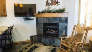 a living room with a fireplace and a tv at Ski Trails 4058 in Truckee