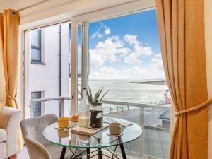 a room with a table and a view of the ocean at Estuary View in Exmouth