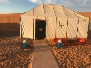 a large tent in the middle of the desert at Camp birds traquets of SaharaProject house mars six doors in Marrakech