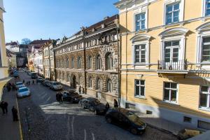 a city street with cars parked next to buildings at Old Town Hostel Alur in Tallinn