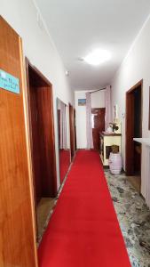 a red carpet in a hallway with a red carpet at Casa Elvezia Guest House in SantʼElpidio a Mare
