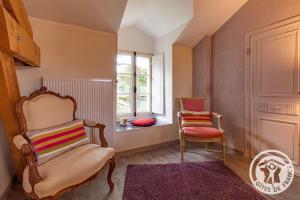 a room with two chairs and a window at Manoir d'Orbé in Montreuil-Bellay +20 photos