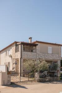 a stone house with a fence in front of it at Red Karmenita in Umag