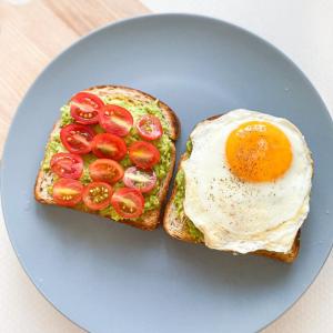 a egg and tomatoes on toast on a blue plate at Redbell Inn Airport Hotel in Kondotti