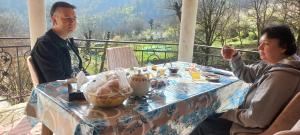 a man and a woman sitting at a table at Sim Guesthouse in Sım +262 photos