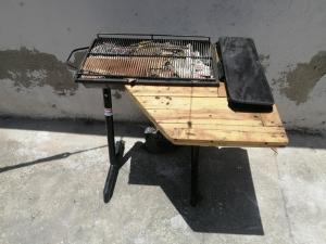 a bird cage sitting on top of a bench at Squid Hostel in Santa Marta
