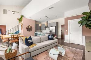 a living room with a couch and a dining room at Mason Lofts at West End in Nashville