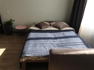a bed in a bedroom with a blue comforter at New apartment 1 in Lviv