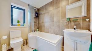 a bathroom with a white sink and a toilet at Chatham Serviced Apartments by Hosty Lets in Chatham