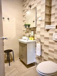 a bathroom with a sink and a toilet at Rainbow House Rooms in Maribor