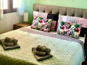 a large bed with pillows and towels on it at Apartment Flamenca , Orihuela Costa in Orihuela +21 photos