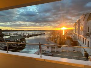 a view from a balcony of a marina at sunset at Harborside Inn in Newport
