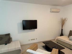 a living room with a flat screen tv on the wall at Apartment Iva in Trogir