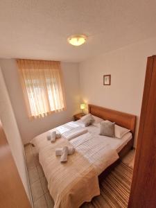 a bedroom with a large bed with towels on it at Apartment Iva in Trogir