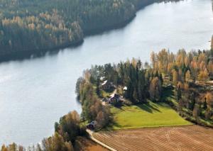 an aerial view of a house on an island in a lake at Löydön Kartano Villas in Mikkeli