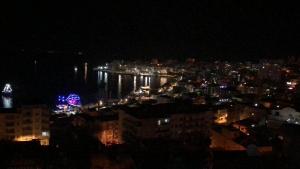 a view of a city at night with lights at Hostel Andrey in Sarandë