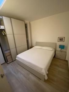 una camera con letto bianco e lampada blu di Casa Borgo Monte a Otranto