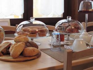una mesa con un plato de pan y pasteles. en La Casa dei Gatti, en Limone Piemonte