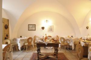 a dining room with two tables and chairs at Locanda Alpina in Brez