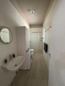 a bathroom with a sink and a toilet and a mirror at Villa BeaBella in Scicli