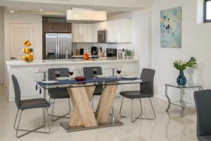 a kitchen with a table with wine glasses on it at Moderno Residences By Bay Breeze in Miami Beach