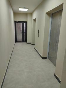 an empty hallway of an office building with doors at ЖК Наурыз парк in Shymkent
