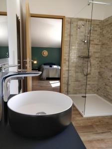a bathroom with a tub and a shower and a sink at Casa voscia in Casalabriva