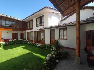 a house with a lawn in front of it at Casa Pablo in Cajamarca