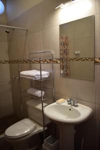 a bathroom with a sink and a toilet and a mirror at Casa Pablo in Cajamarca