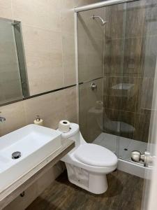 a bathroom with a sink and a toilet and a shower at Apartamento Completo, cerca a Mall Aventura Plaza in Trujillo