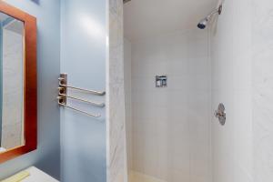 a bathroom with a shower with a glass door at Wintergreen 125 in Blue Mountains