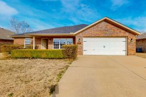 a brick house with a garage at The Brick Beauty on Cabriolet in Bentonville