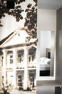 a mirror with a picture of a building on the wall at Pensjonat Zdrojowy Apartamenty in Rabka +77 photos