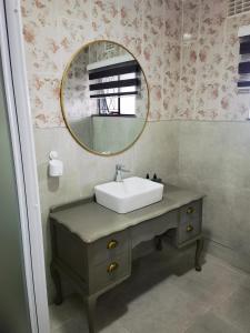 a bathroom with a sink and a mirror at Safi Luxury Self-Catering Suite 8 in East London