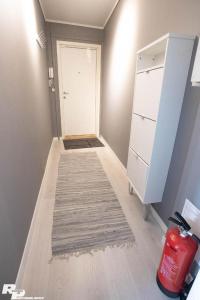 a room with a hallway with a door and a rug at Ålesund City Center - Modern 80-m2 flat with 3 bedrooms in Ålesund