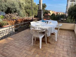 a white table and chairs on a patio at Da Mamma IUN Q9152 in Santa Maria Navarrese