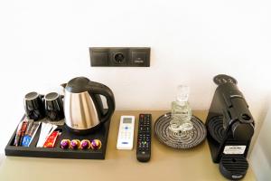 a table with a coffee maker and other items on it at Lefka Ori - Agia Galini in Agia Galini