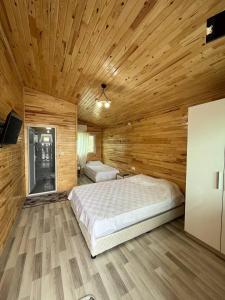 1 dormitorio con techo de madera y 2 camas en Silahcılar apart pansiyon, en Kumluca