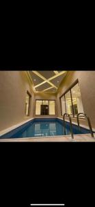 a swimming pool in the middle of a house at Al Narjes Villas & Apartments in Riyadh