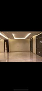 a large room with a large room with white walls at Al Narjes Villas & Apartments in Riyadh