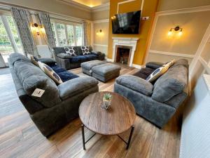 a living room with a couch and a table at Lydney House Swaffham Sleeps 22 in Swaffham