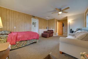 a bedroom with a bed and a couch at Cozy Houghton Lake Heights Cottage with Private Yard in Houghton Lake