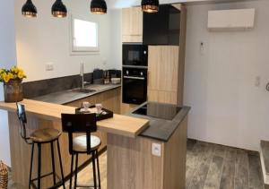 a kitchen with a counter with a sink and a stove at LE ROMARIN-TOPDESTINATION-AUPS in Aups