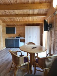 a kitchen with a table and chairs in a room at Siodemkacamp Karwia in Karwia