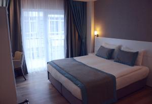 Postel nebo postele na pokoji v ubytování ParionHouse Hotel